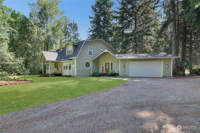 front of property with a garage, a front yard, and covered porch