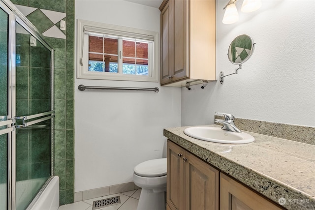 full bathroom with tile patterned floors, vanity, toilet, and enclosed tub / shower combo