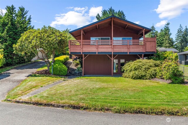 view of front of house featuring a front yard and a deck