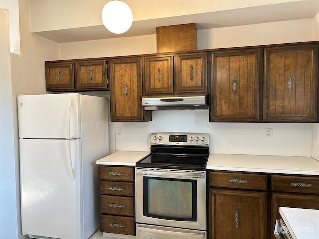 kitchen featuring dark brown cabinets, stainless steel electric range oven, and white fridge