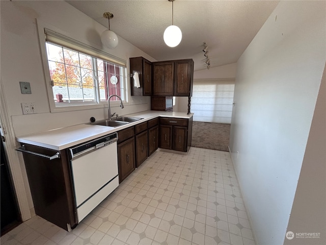 kitchen with dishwasher, dark brown cabinetry, a textured ceiling, sink, and decorative light fixtures