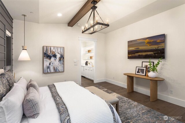 bedroom featuring a chandelier, dark hardwood / wood-style flooring, lofted ceiling with beams, and ensuite bathroom