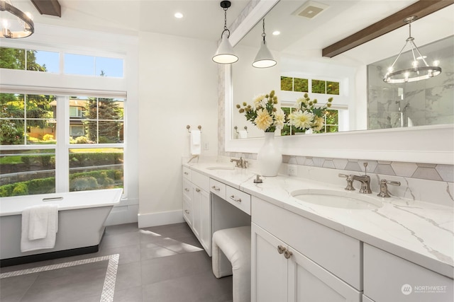 bathroom with a tub to relax in, tile patterned floors, vanity, an inviting chandelier, and beamed ceiling