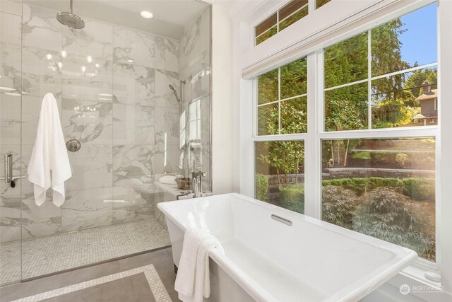 bathroom with tile patterned floors and shower with separate bathtub