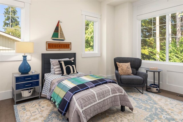 bedroom featuring wood-type flooring and multiple windows