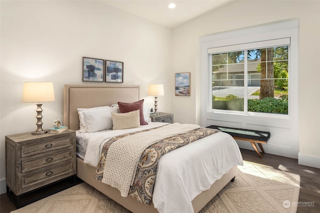 bedroom featuring light hardwood / wood-style flooring and vaulted ceiling