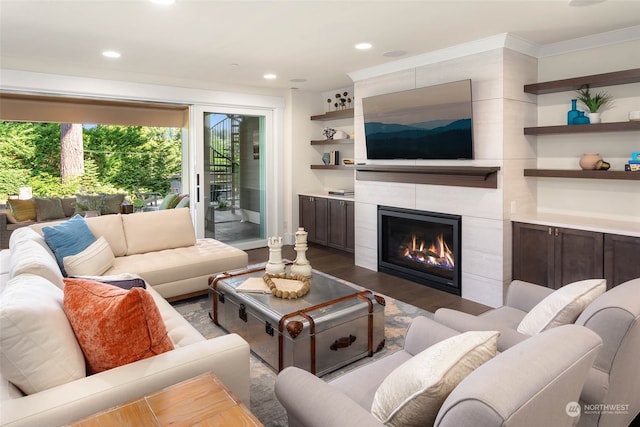 living room featuring a tile fireplace and hardwood / wood-style flooring