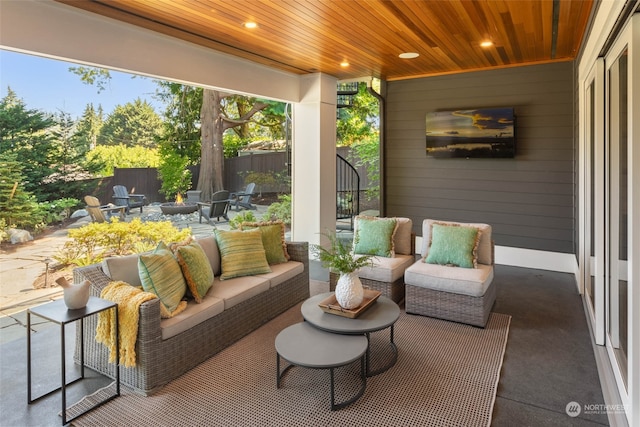 sunroom featuring a wealth of natural light and wooden ceiling