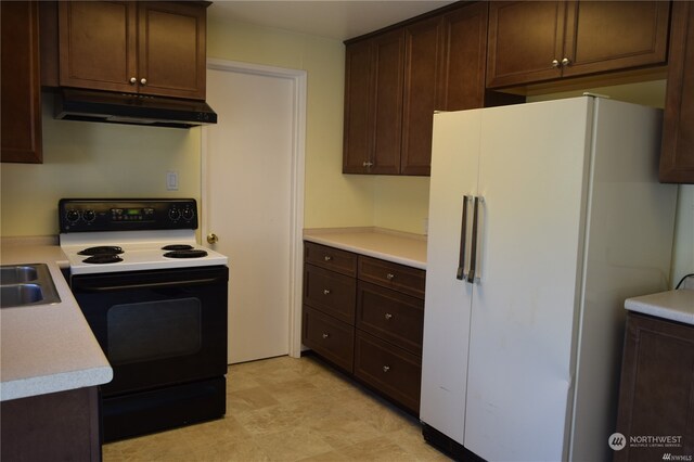 kitchen featuring sink, dark brown cabinets, light tile patterned floors, and white appliances