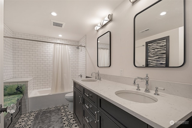 full bathroom with tile patterned floors, vanity, shower / tub combo, and toilet