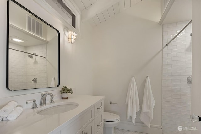470 Friday Ave, Friday Harbor, WA 98250 - bathroom with beam ceiling, visible vents, toilet, vanity, and tiled shower