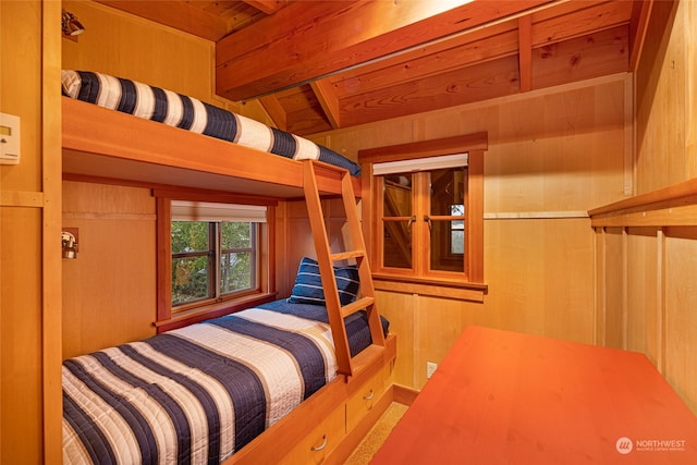 bedroom featuring wooden walls, beamed ceiling, and wood ceiling