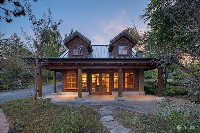 view of back house at dusk