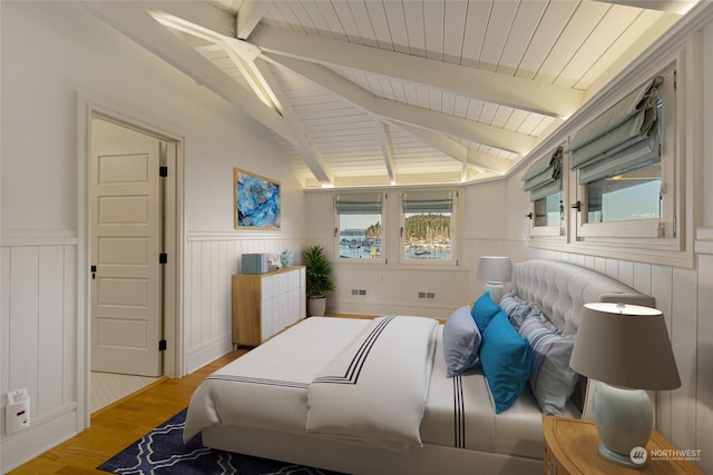470 Friday Ave, Friday Harbor, WA 98250 - bedroom featuring a wainscoted wall, vaulted ceiling with beams, and light wood-style flooring