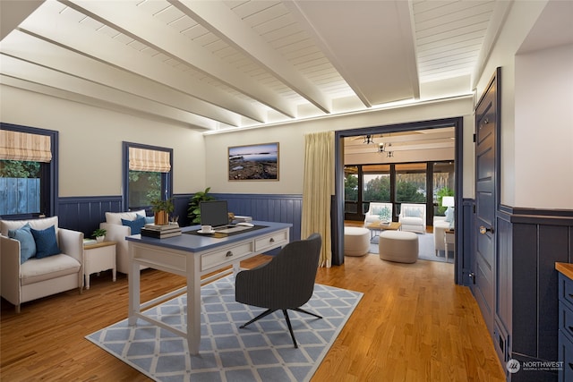 home office with beamed ceiling and light hardwood / wood-style flooring