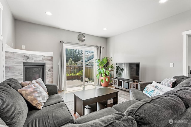 living room with light hardwood / wood-style flooring and a high end fireplace