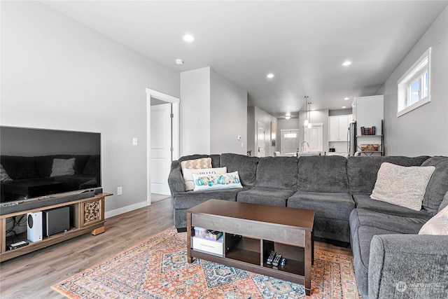 living room featuring light hardwood / wood-style flooring and sink