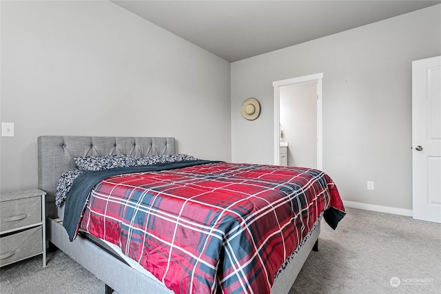 carpeted bedroom featuring ensuite bathroom