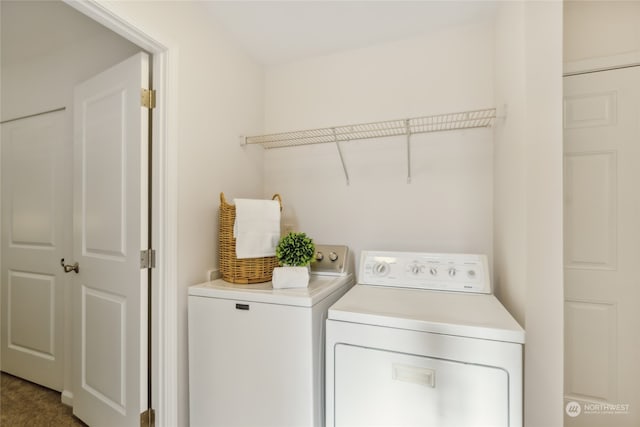 clothes washing area featuring washer and dryer and laundry area