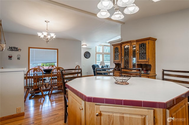 935 Sunrise Dr, Manson, WA 98831 - kitchen featuring a chandelier, healthy amount of natural light, light wood finished floors, a kitchen island, and lofted ceiling