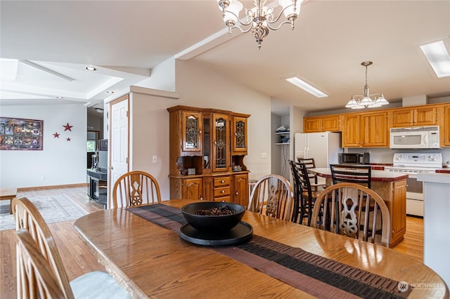 935 Sunrise Dr, Manson, WA 98831 - dining room featuring a chandelier, light wood-style floors, and vaulted ceiling