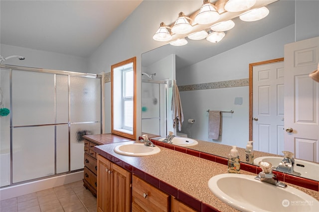 935 Sunrise Dr, Manson, WA 98831 - full bathroom with vaulted ceiling, a shower stall, double vanity, and tile patterned floors