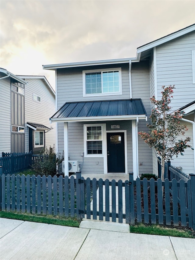 view of front of home featuring ac unit