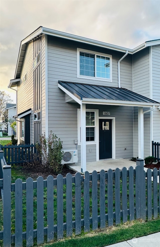 view of front facade featuring ac unit and covered porch