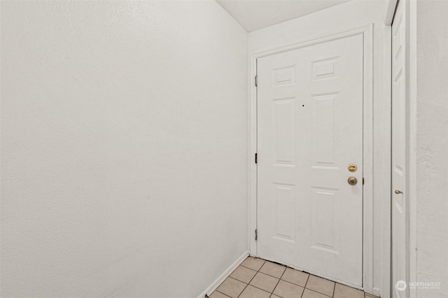 doorway with light tile patterned floors