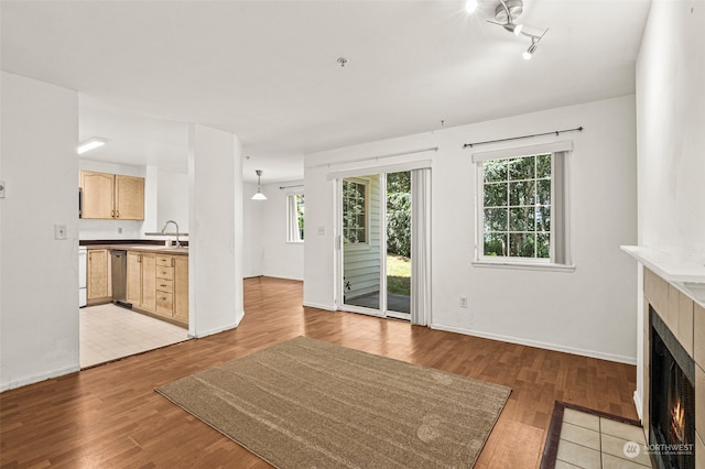 unfurnished living room with plenty of natural light and light hardwood / wood-style floors