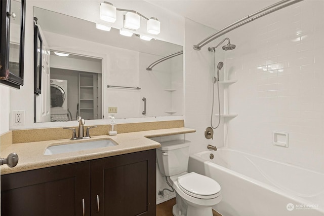 full bathroom featuring vanity, toilet, tiled shower / bath combo, and stacked washing maching and dryer