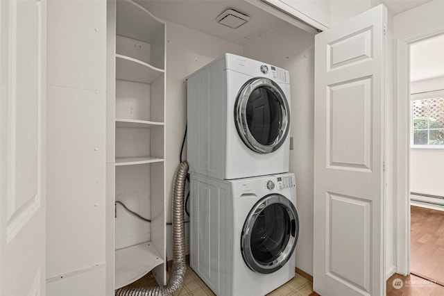 washroom featuring stacked washer / drying machine