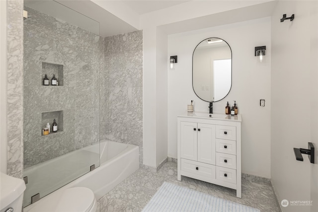 full bathroom with vanity, toilet, tiled shower / bath combo, and tile patterned floors