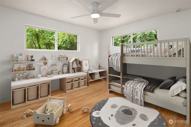 bedroom with multiple windows, ceiling fan, and hardwood / wood-style flooring