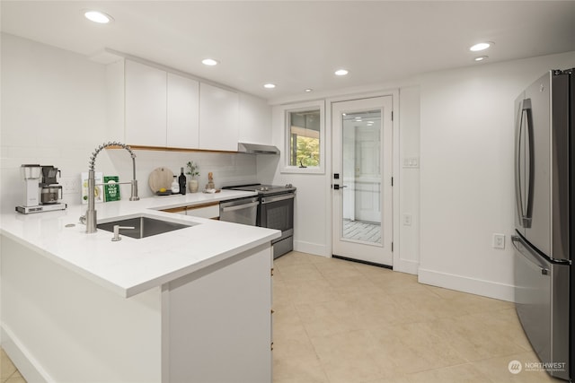 kitchen with white cabinetry, light tile patterned floors, sink, decorative backsplash, and appliances with stainless steel finishes