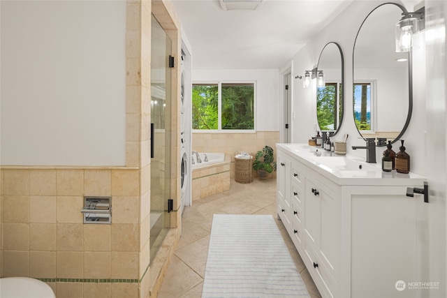 bathroom featuring tile patterned flooring, shower with separate bathtub, and vanity