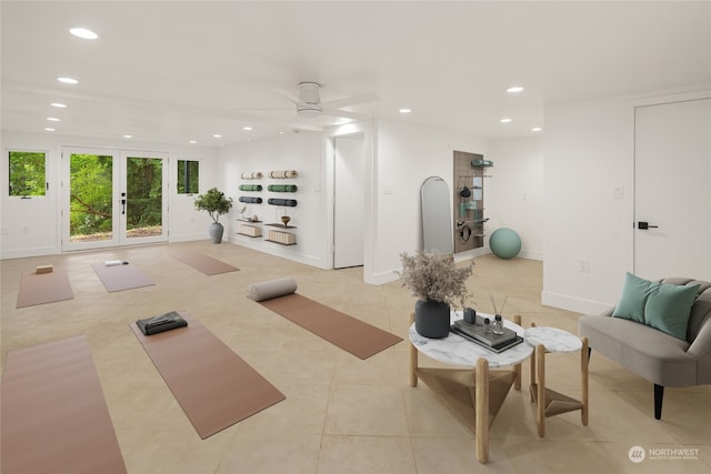 exercise room featuring ceiling fan, light tile patterned floors, and french doors