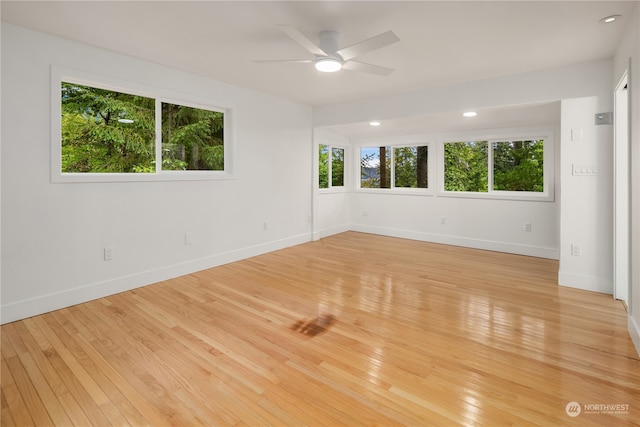 spare room with ceiling fan and light wood-type flooring