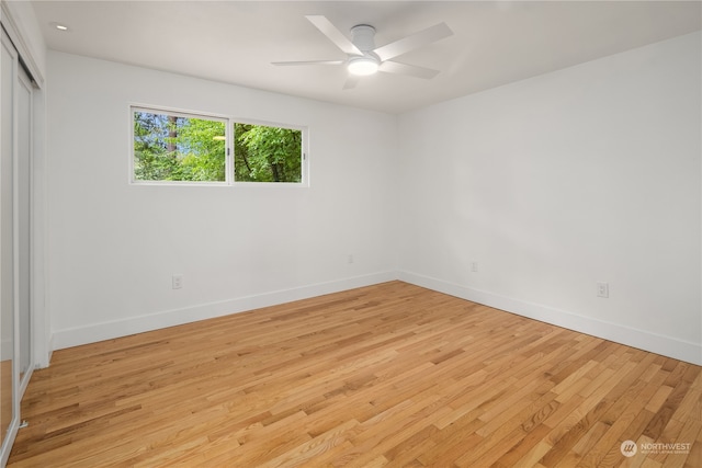 empty room with light wood-type flooring and ceiling fan