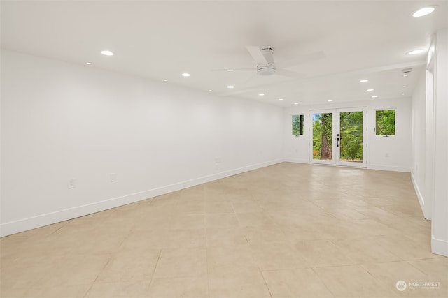 tiled empty room with french doors and ceiling fan