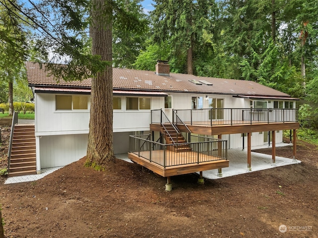 rear view of property featuring a deck