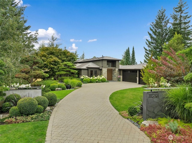 prairie-style house featuring a front yard and a garage