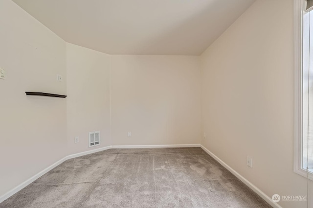 unfurnished room featuring light colored carpet