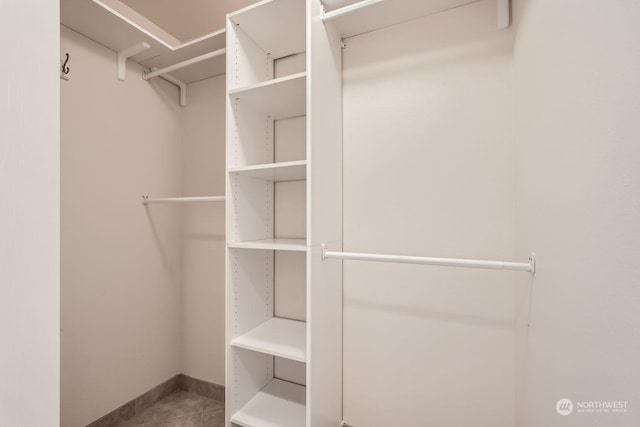 spacious closet featuring tile patterned floors