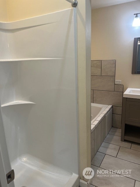 bathroom with vanity, plus walk in shower, and tile patterned floors