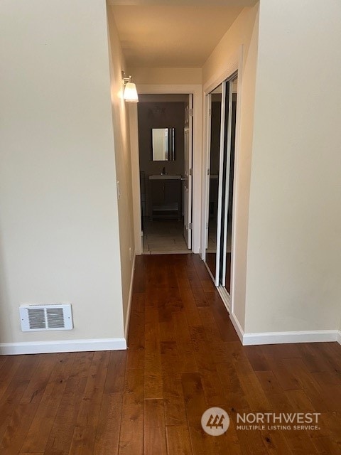 hall with dark wood-type flooring