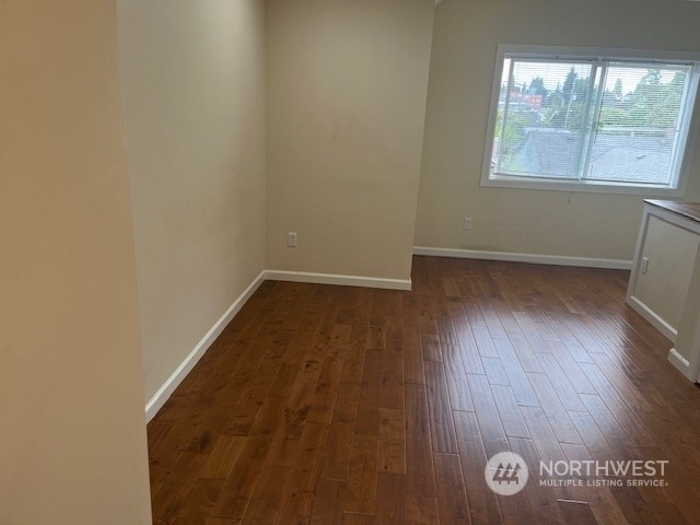 unfurnished room with dark hardwood / wood-style floors