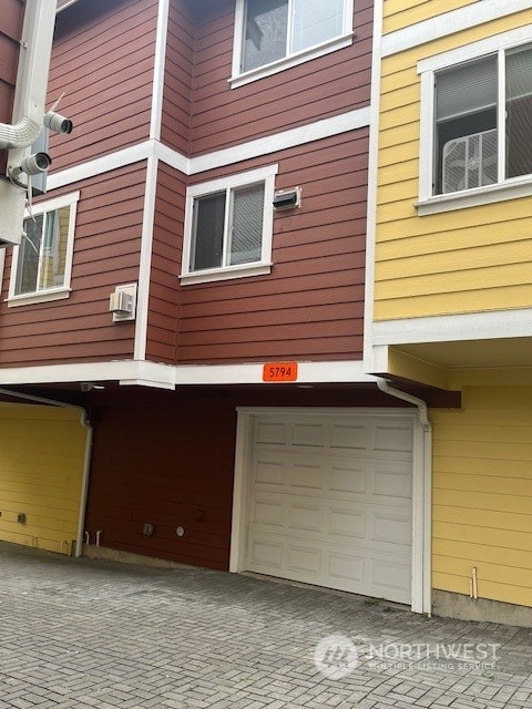 view of side of home featuring a garage