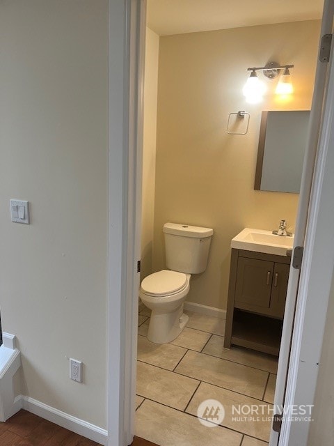 bathroom with tile patterned floors, toilet, and vanity