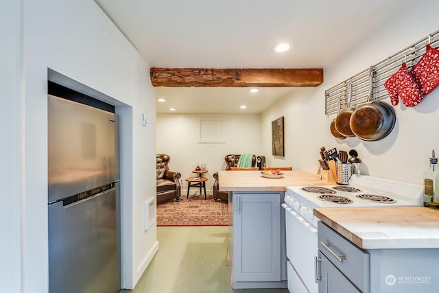 kitchen with electric stove, stainless steel fridge, and beamed ceiling